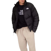The North Face puffer jacket for men in black with quilted design and logo on chest, front view