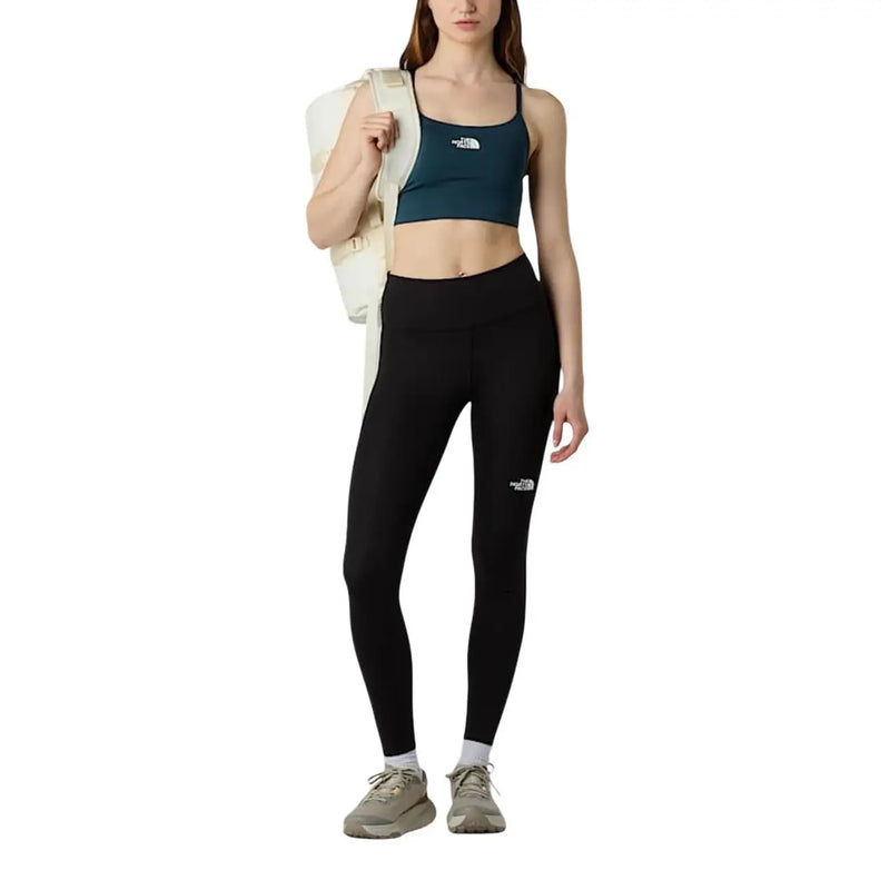 Black high-waisted leggings with white logo on left thigh made of polyester elastane by The North Face women trousers