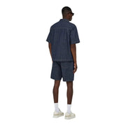 Only loose shorts ONSFA for men in dark blue denim with subtle vertical stripes, worn by model front view