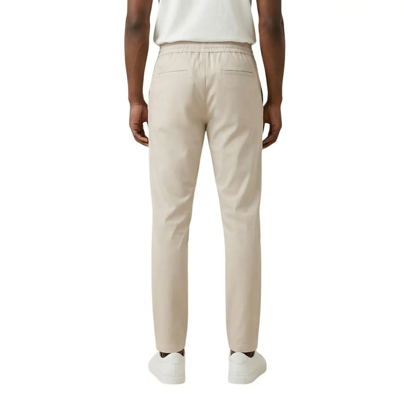 Beige cotton chino trousers with elastic waistband and two rear pockets shown from the back by Only Sons men trousers