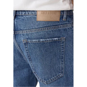 Back side of only and sons men light blue cotton jeans featuring a tan leather brand patch on the waistband