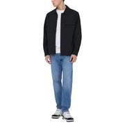 Black button up jacket with classic collar and chest pocket worn over white tee paired with only and sons men light blue cotton jeans