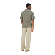 A man wears an olive green short-sleeved button-up shirt with classic collar and relaxed fit by Only Sons