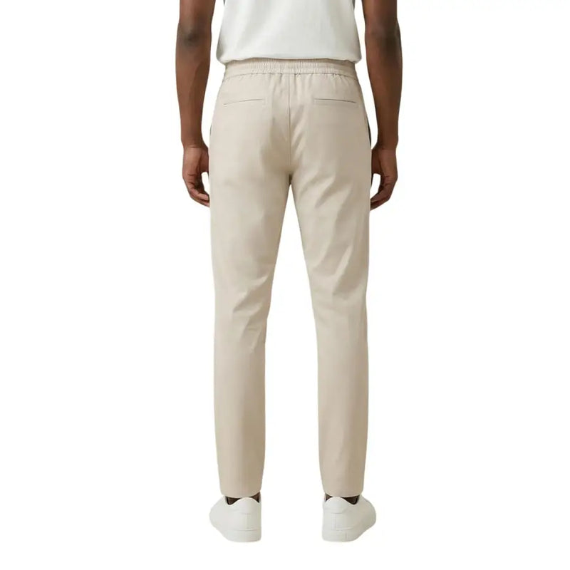 Beige cotton chino trousers with elastic waistband and two rear pockets shown from the back by Only Sons men trousers