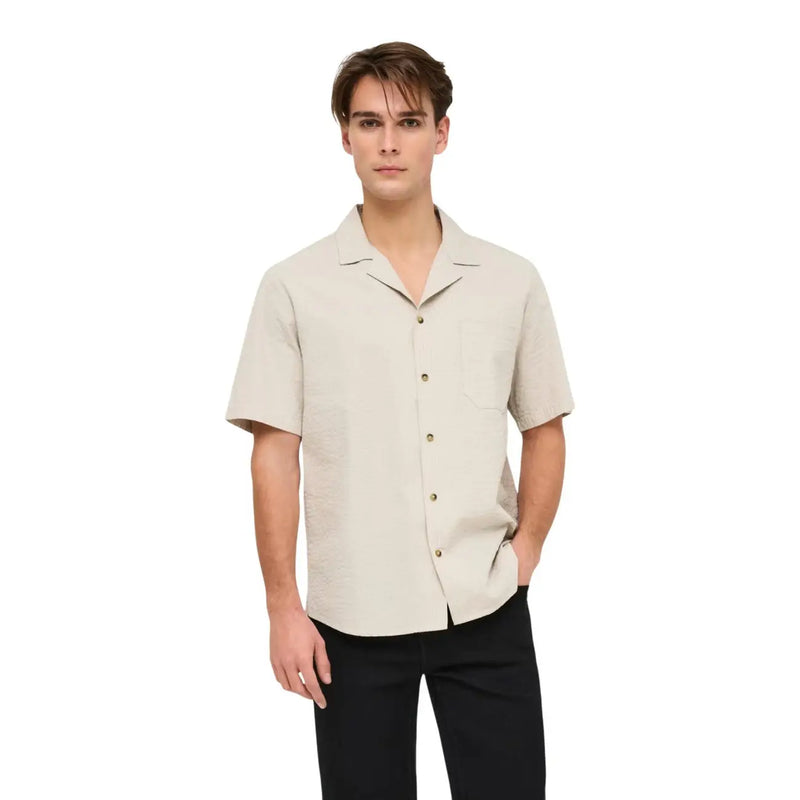 Only and Sons mens blue cotton resort shirt with short sleeves collar and front pocket in beige shown from front