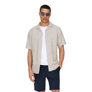 Beige mens short-sleeved linen blend resort shirt by Only And Sons with button-up front collar and subtle texture