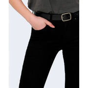 Black leather belt with silver rectangular buckle paired with only women black cotton jeans with plain zip button