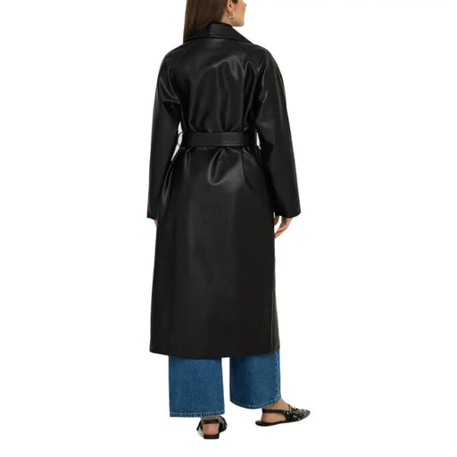 Black full-length faux leather trench coat with belted waist displayed on a model
