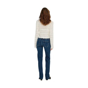 A woman wearing only women blue mid straight jeans cotton denim paired with a cream crochet lace top