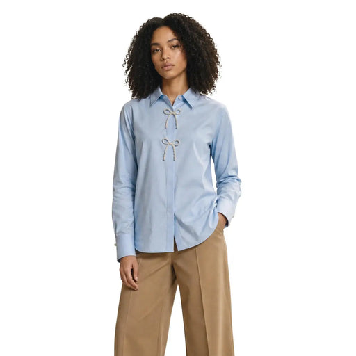 Only women light blue cotton long polo shirt with pearl detail featuring decorative white bow at the front