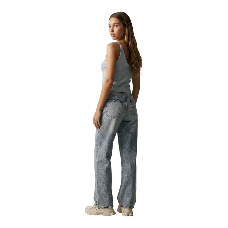 Light-wash denim jeans with relaxed straight-leg cut paired with only women light blue glitter shina strap tank top