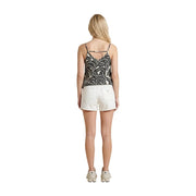 A woman wearing an only women black viscose tank top with v neck and thin straps paired with cream shorts