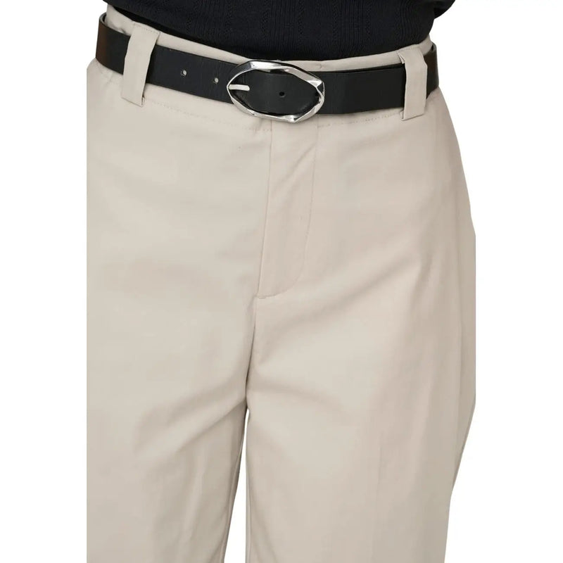 Black leather belt with silver-toned oval buckle paired with only women beige cotton stretch trousers size 30
