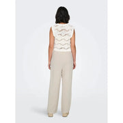 A delicate off-white crochet top with scalloped edge paired with beige linen viscose wide-leg trousers spring summer
