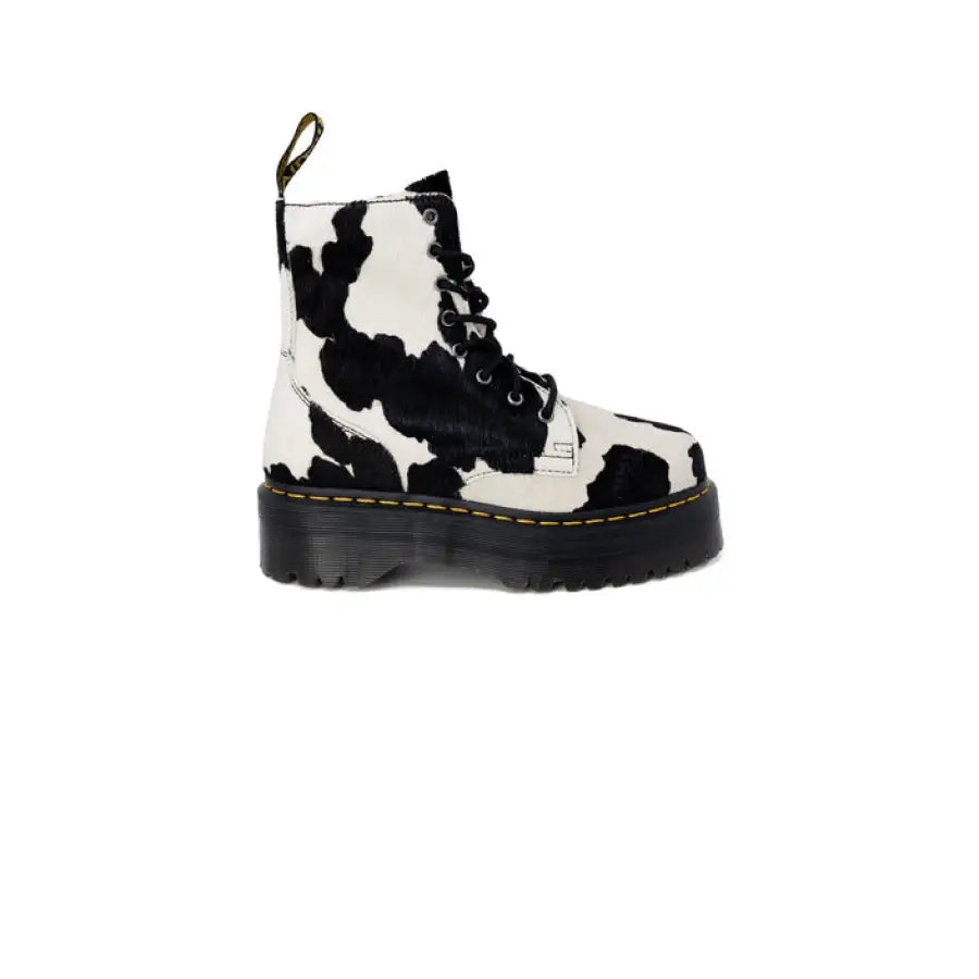 Dr. Martens women boots in cow print, trendy black and white design