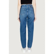 High-waisted blue jeans worn by a model showcasing Calvin Klein Jeans Women’s collection