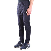 Men’s dark blue slim-fit cotton stretch trousers paired with sneakers for a stylish look