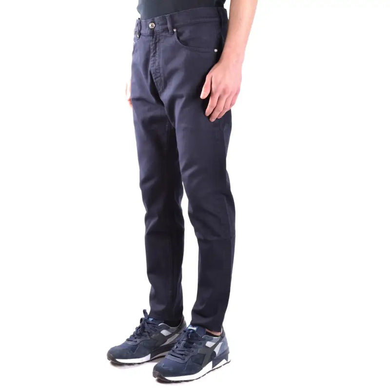 Men’s dark blue slim-fit cotton stretch trousers paired with sneakers for a stylish look
