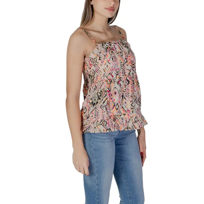 Pink sleeveless B.young women’s cotton tank top with vibrant pink orange and black geometric pattern on beige fabric