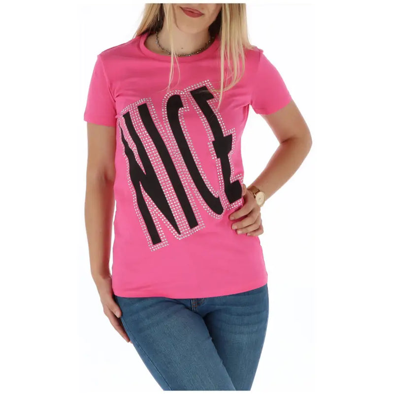 A vibrant pink short-sleeved t shirt with the word nice in bold black letters outlined with sparkling rhinestones