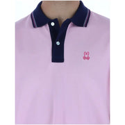 Psycho Bunny men polo shirt pink short sleeve cotton with navy blue collar and small embroidered pink bunny logo