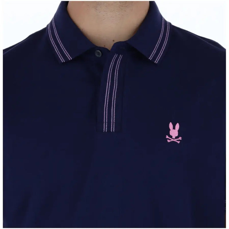 Navy blue Psycho Bunny men polo short sleeve cotton shirt with white double-stitching and pink embroidered logo