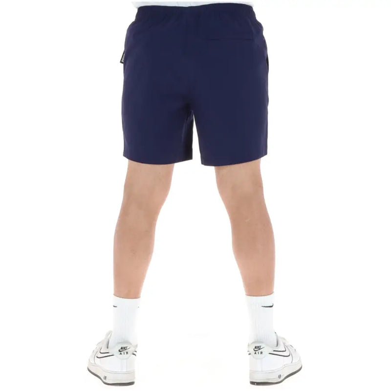 Navy blue Psycho Bunny men swimwear athletic shorts with drawstring waistband and side pockets for active use