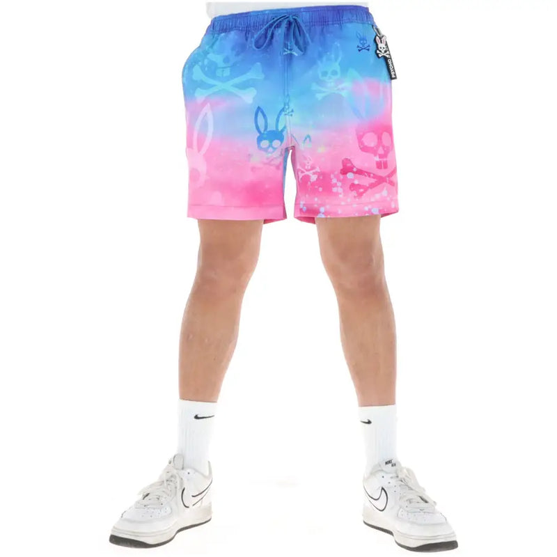 Psycho Bunny men swimwear shorts with vibrant blue and pink gradient and skull crossbones and bunny motifs printed on fabric