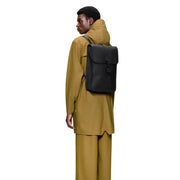 Black minimalist rains unisex backpack mini with sleek rectangular design flap closure and waterproof material