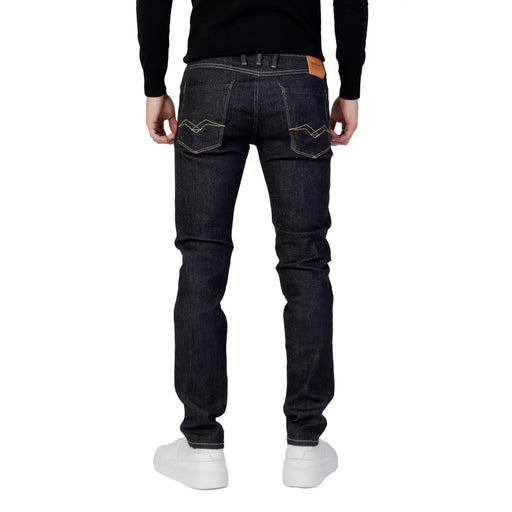 Dark indigo Replay men blue slim fit denim jeans with white stitching and brown leather patch on waistband back side