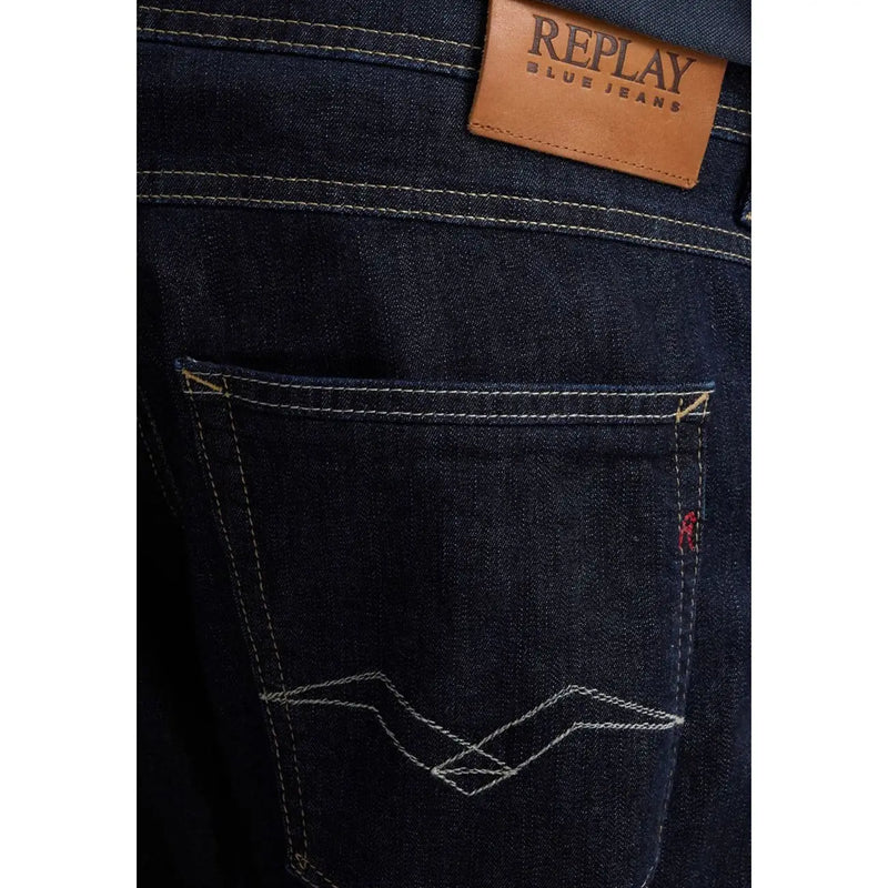 Dark blue denim replay men jeans with brown leather brand patch and white zigzag stitch on back pocket spring summer
