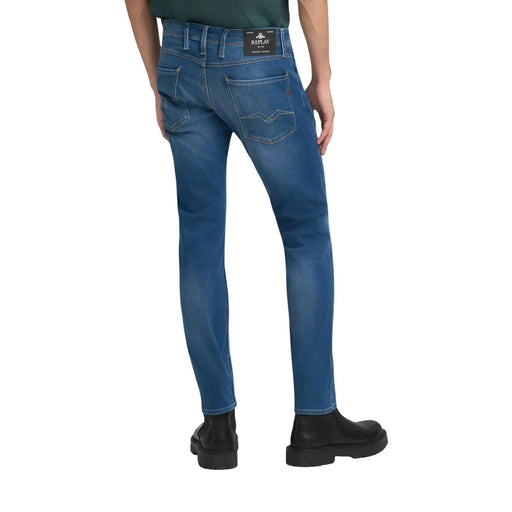 Back side of blue slim fit replay men jeans with subtle fading and classic fit featuring brand label on waistband