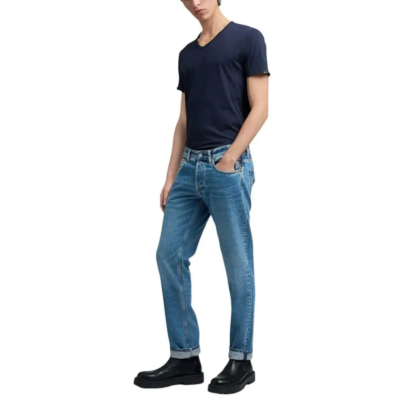 Eine klassische blaue Replay-Herrenjeans aus Denim mit geradem Bein, umgeschlagenen Säumen und hellblauen Reißverschlusstaschen.