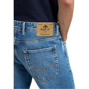 Back side of replay men jeans light blue denim featuring tan leather brand patch and gold stitching on pocket