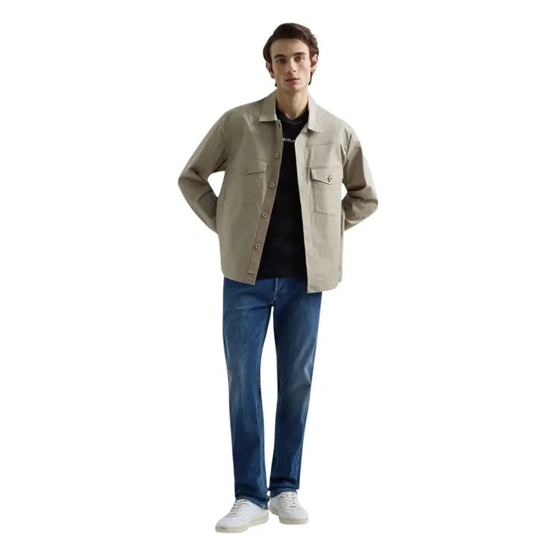 Beige utility-style jacket with button closures and two chest pockets paired with replay men straight leg blue stretch denim jeans