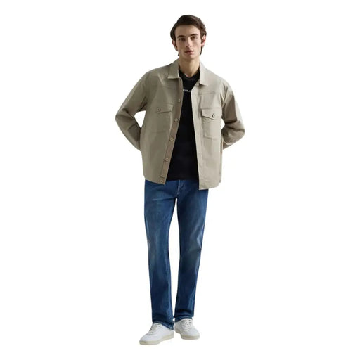 Beige utility-style jacket with button closures and two chest pockets paired with replay men straight leg blue stretch denim jeans