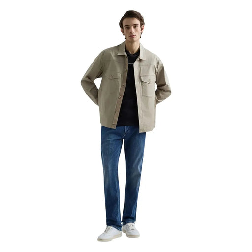 Beige utility-style jacket with button closures and two chest pockets paired with replay men straight leg blue stretch denim jeans