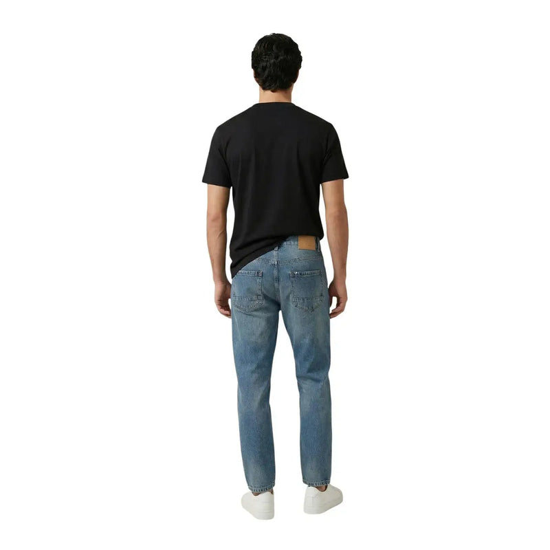 Replay men t-shirt paired with light-wash denim jeans featuring a classic five-pocket design and leather patch on back waistband