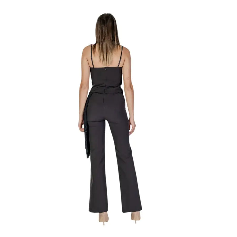 Black sleeveless Rinascimento jumpsuit with thin straps and flared legs featuring a square neckline design