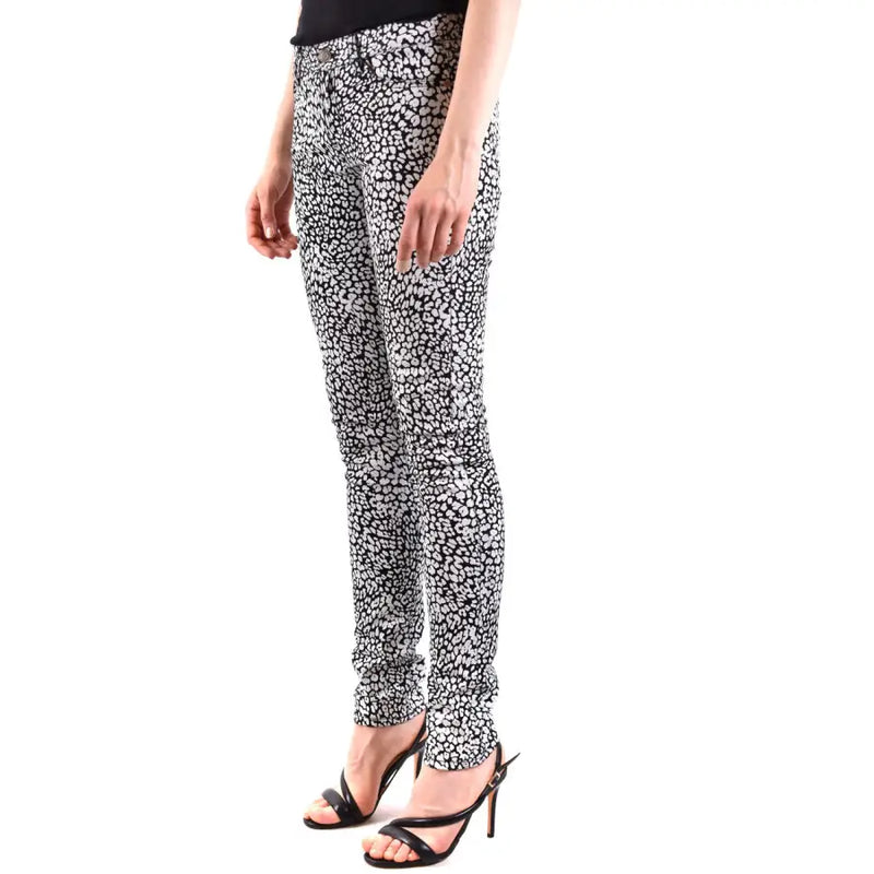 Saint Laurent white leopard print women jeans featuring black and white skinny denim with a bold animal pattern