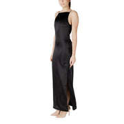 A sleeveless black satin maxi dress with thin spaghetti straps and a high side slit