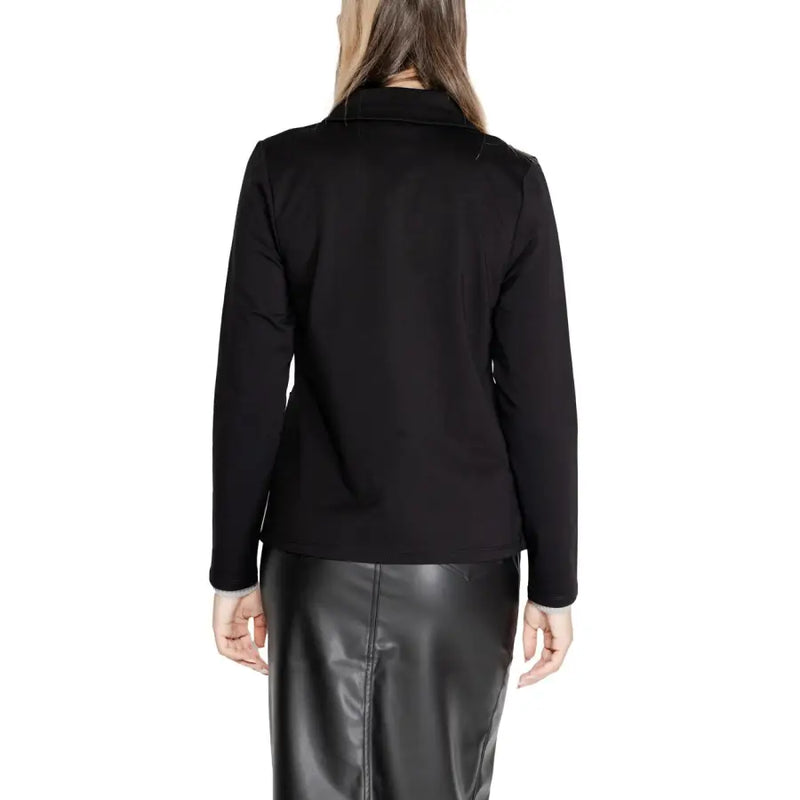 Woman wearing a black blazer and leather skirt from Street One for a sophisticated look