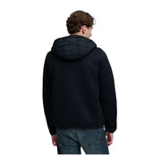 Superdry Veste à capuche en maille hybride pour homme, noire, matelassée, avec détails de surpiqûres discrets (vue de face).
