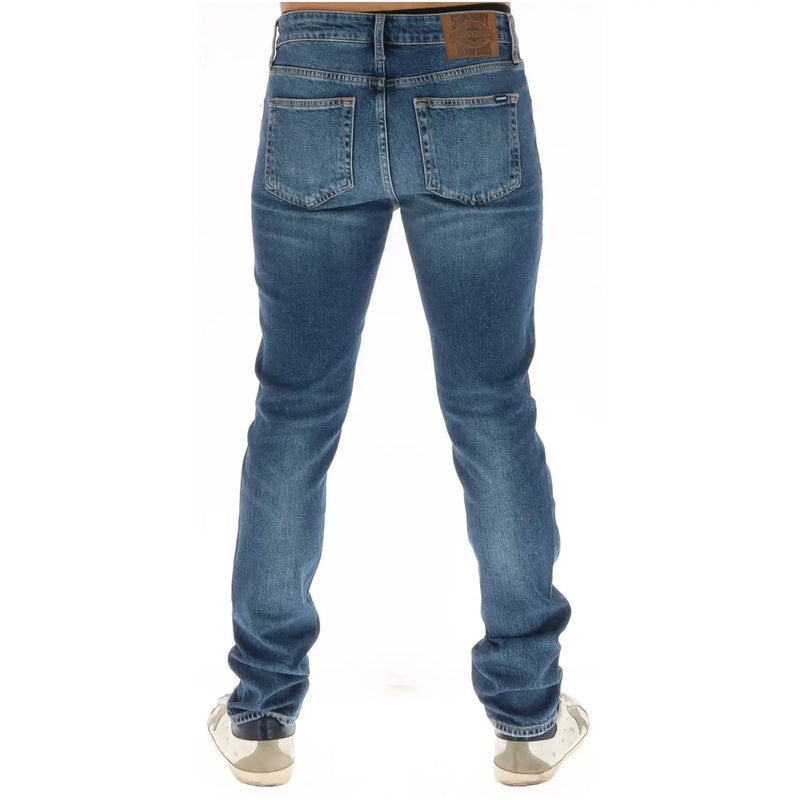 Superdry jeans for men in blue denim with faded wash back pockets and brown leather patch, back view