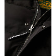 Black superdry everest puffer jacket zipper pull with white lettering on hooded long winter men jacket m5011743a