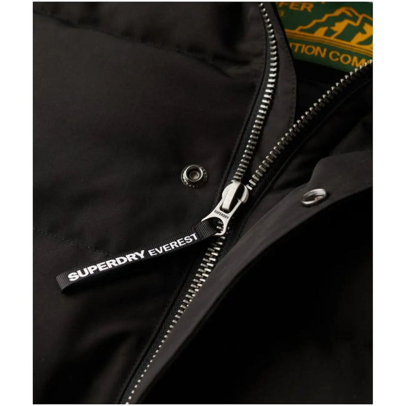 Black superdry everest puffer jacket zipper pull with white lettering on hooded long winter men jacket m5011743a