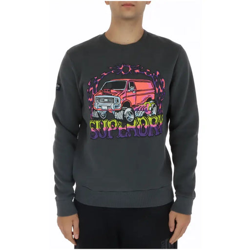 Dark gray crewneck sweatshirt with a vibrant psychedelic pink van graphic and rainbow superdry lettering