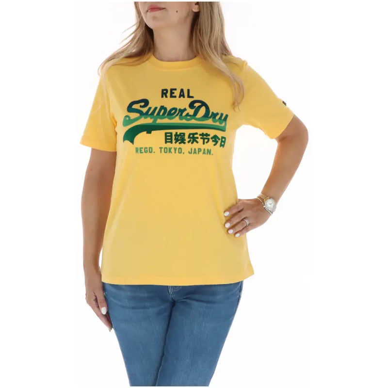 Yellow superdry women t-shirt with green logo and Japanese text from fall winter collection