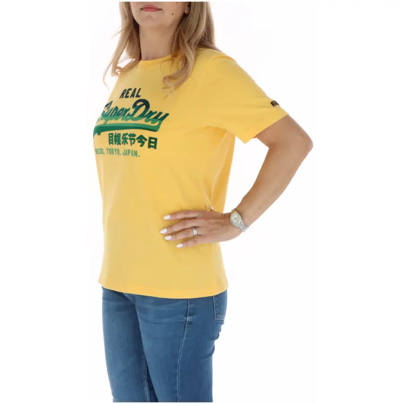 Yellow superdry women t-shirt with green logo and English and Chinese text from fall winter collection