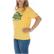 Yellow superdry women t-shirt with green logo and English and Chinese text from fall winter collection